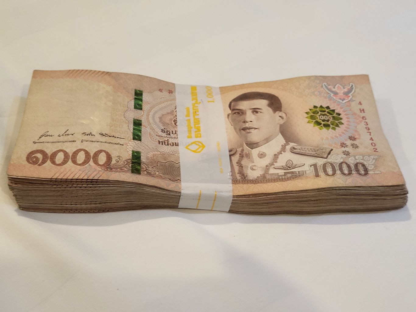 100,000 Thai Baht wrapped up in a bank tie
