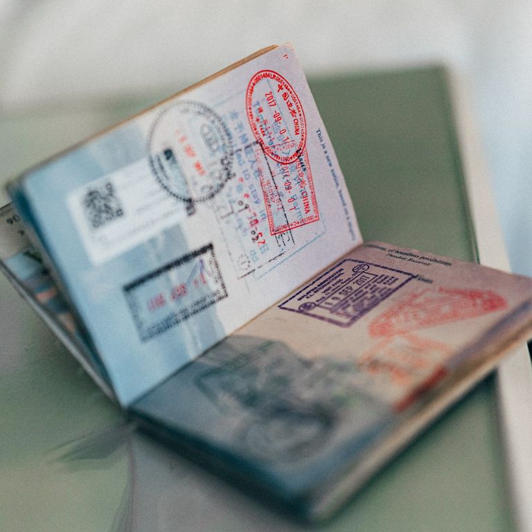 photo of a passport open and showing travel stamps
