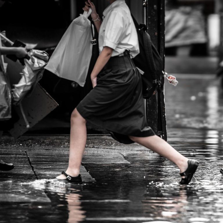 image of Thai girl paddling in flood water